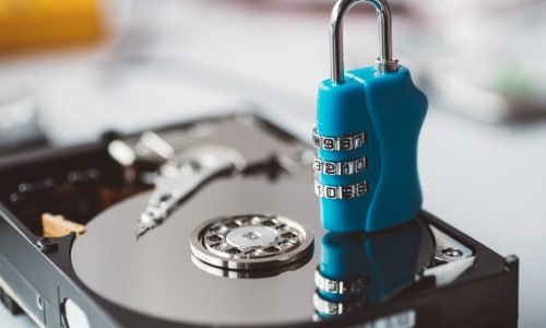 Cipher padlock on opened hard disk. Encrypted disk drive. Data security